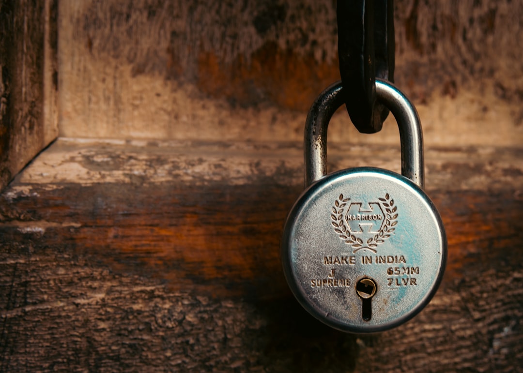 A vintage padlock hangs on a wooden surface